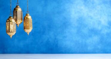 Three ornate golden lanterns against a textured blue background. photo