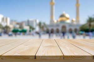 Blurred background of a mosque with a wooden tabletop in the foreground. photo