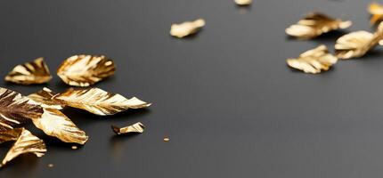 Golden leaves scattered on black, elegant background. Luxury design photo