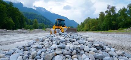 Loader moves rocks, mountain backdrop. Construction site photo