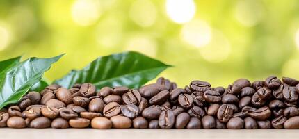 Coffee beans with green leaves, set against a blurred natural background. photo