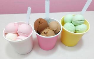 Three cups filled with ice cream and different colored eggs photo