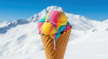 A cone of ice cream with rainbow colored toppings on top of a mountain photo