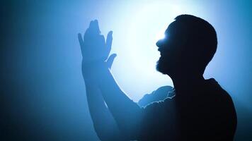 Silhouette of a Person applauding Engaged in a Deeply Emotionally Charged Moment of Expression video