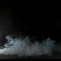 Smoke coming out of a car on a black background photo