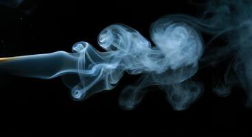 Smoke is being blown out of a cigarette photo