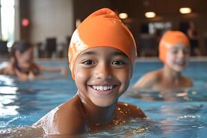 Portrait of smiling child wearing orange swim cap in swimming pool photo