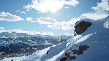 Snow blowing off rock on sunny mountain top photo