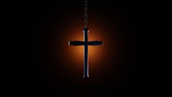 A cross hanging from a chain on a dark background video