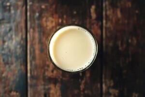 Glass of soy milk resting on rustic wooden table photo