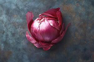 Red onion bulb with dry outer layers on dark background photo