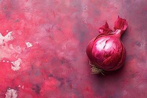 Red onion bulb resting on a vibrant red textured background photo
