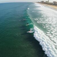 A group of surfers riding the waves of the ocean photo