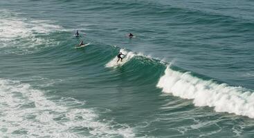 A group of people on surfboards riding waves in the ocean photo