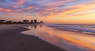 A beach with a colorful sunset and buildings in the background photo