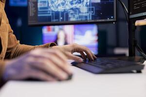 Software engineer uses computer for artificial intelligence computing simulating human brain through self learning algorithms, close up shot. IT expert types code, working with AI deep neural networks photo