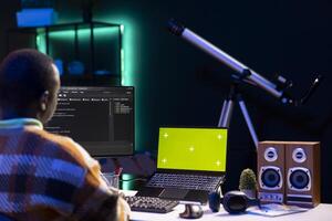On terminal window, server technician optimizing program and next to green screen, integrating HTML tags with IT technical language. Database handled by self employed software expert. photo