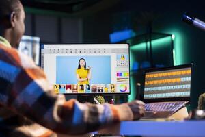 Professional graphic designer retouching images on dual monitors in a creative office environment, demonstrating multitasking skills and innovative techniques. Well organized editor. photo