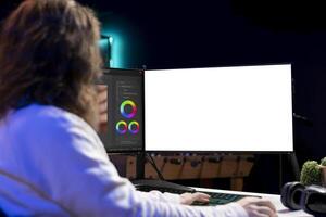 Videographer uses editing software on mockup computer to assemble footage into cohesive final result. Expert color correcting clips on isolated screen PC to ensure project meets desired aesthetic photo