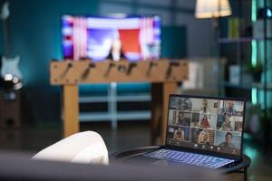 Teleworker and coworkers in call crosschecking analytics statistical data sets in dimly lit apartment office. Employee optimizing key performance indicators with colleagues in videocall photo