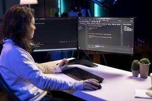Cybersecurity expert using computer to look for company security vulnerabilities and prevent malware infections. Technician installing fortified code on PC to prevent cyberattacks photo