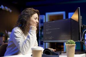 Cheerful computer engineer satisfied after futureproofing company network from downtimes and unexpected system failures. Upbeat IT admin pleased after managing to increase data security photo
