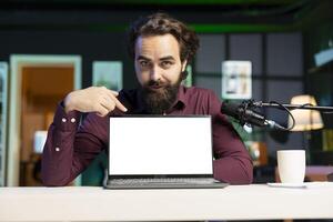 Tech guru assessing isolated screen laptop performance, talking about components used inside. Portrait of content creator shooting mockup notebook review for online channel photo