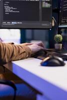 Teleworking programmer securing company servers from virus attacks to avoid unwanted failures. IT remote employee writing code to build firewalls protecting data from threats, close up shot photo