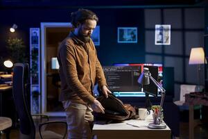 Programmer starting job shift, ready to do software quality assurance and read source code on computer screen. Developer arriving at work in home office to inspect coding on desktop PC photo