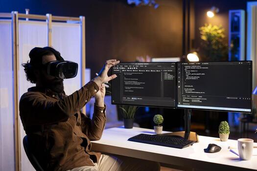 Programmer using high tech VR headset to secure company servers from virus attacks. IT remote employee building firewalls protecting data using futuristic virtual reality technology photo