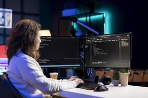 Freelancing computer scientist securing company servers from virus attacks to avoid unwanted failures. IT remote worker writing code to build firewalls protecting data from risks photo