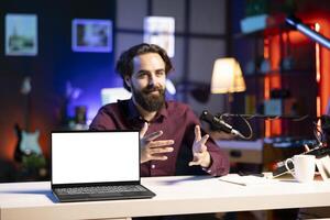 Entertainer presents mockup laptop from brand sponsoring , closely analyzing features. Content creator reviewing isolated screen notebook for technology enthusiasts, inspecting materials photo