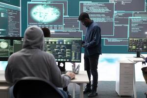 Governmental hackers analyzing data for cyber threat detection, looking at a big screen in high tech office. Highlight cyber intelligence, online security and prevention of digital threats. photo