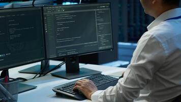 Engineer overseeing data center, making routine improvements and updates to ensure system can handle all networking tasks. Server room employee tracking network traffic and activity, camera A photo