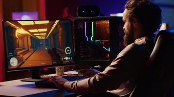 Man playing first person shooter videogame with automatic gun shooting laser bullets at flying robotic foes. Gamer competing in PvP online multiplayer game tourney against opponents photo