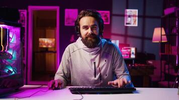 Pro gamer wearing headphones playing game, teaching audience professional esports players skills. Content creator in gaming chair talking with audience, filming tutorial on how to defeat enemies photo