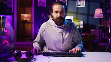 Pro gamer playing intense game, teaching audience professional esports players skills. Man in gaming chair talking with audience, filming tutorial in how to defeat enemies photo