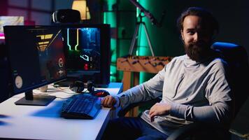 Portrait of cheerful man playing first person shooter videogame with automatic gun shooting laser bullets at flying robotic foes. Smiling gamer competing in PvP online multiplayer game photo