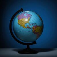 A globe on a stand against a dark background photo