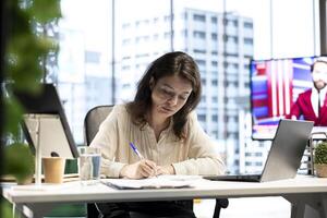 Business CEO with authority and executive power signing work contracts, solving her daily tasks of authorizing different requests from department employees. Jurisprudence paperwork. photo
