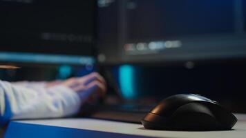 Programmer typing on computer to fix vulnerabilities in software enabling attackers to compromise systems. Woman taking care of security exposures in operating system, writing code, camera Bclose up photo