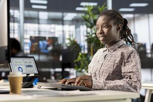 African american manager analyzing company data for strategic planning, solving resource allocation and effective business operations. Expert does financial forecasting and data analysis. photo