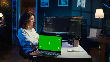 Programmer designing and developing software applications using isolated screen laptop. IT professional implementing and maintaining company systems using mockup notebook, camera B photo