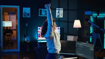 Programmer stretches body limbs after securing company servers from virus attacks all day. Fatigued IT remote employee relaxing tense muscles at desk after building firewalls protecting data, camera B photo