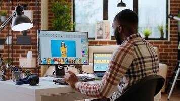 Freelance graphic designer editing photos on a modern computer setup in a remote office. Ideal workspace for a digital design professional, retouching digital pictures from home. Camera B.
