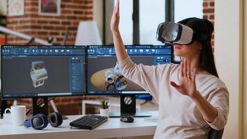 Asian woman engineer creating prototypes with vr glasses and 3D modeling software, working from home to develop new manufacturing gears and turbines. 3D design tech tools. Camera B. photo