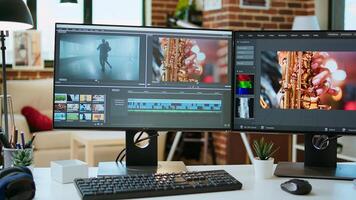 Empty office desk with a editing software running on computer, production and mixing to edit footage. Professional program for filmmaking media, creative studio. photo