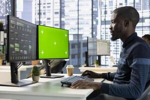 Developer conducting experiments and tests on green screen computer to optimize machine learning models for performance and accuracy. IT expert in office analyzing complex AI data on mockup PC photo