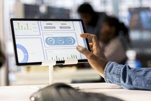 African american manager analyzing company data for strategic planning, solving resource allocation and effective business operations. Expert does financial forecasting and data analysis. Close up. photo