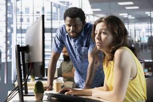Developer and colleague doing brainstorming, fixing applications issues, dealing with databases and server configuration. IT expert and coworker optimizing company software for improved performance photo